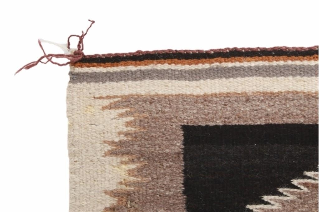 Artwork by Mae Benally, Navajo Eye Dazzler Crownpoint rug, Made of Dyed colors of light brown, black, grey, heathered grey, and cream set to a black field.