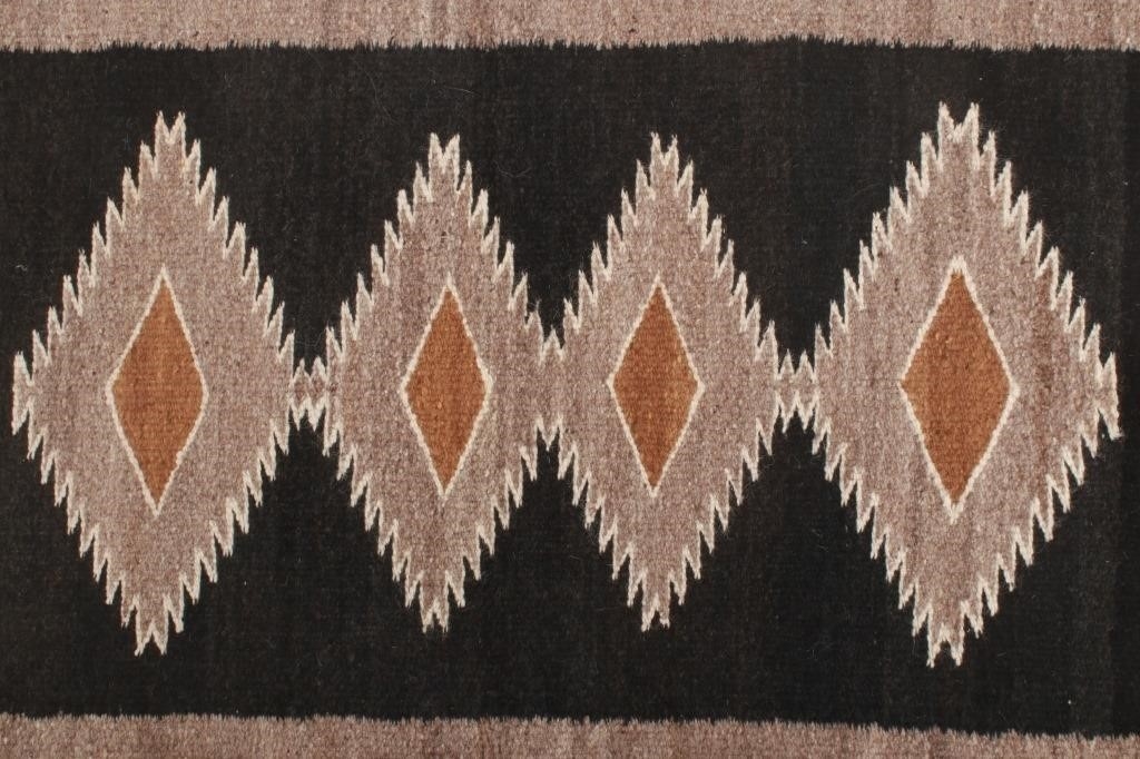 Artwork by Mae Benally, Navajo Eye Dazzler Crownpoint rug, Made of Dyed colors of light brown, black, grey, heathered grey, and cream set to a black field.