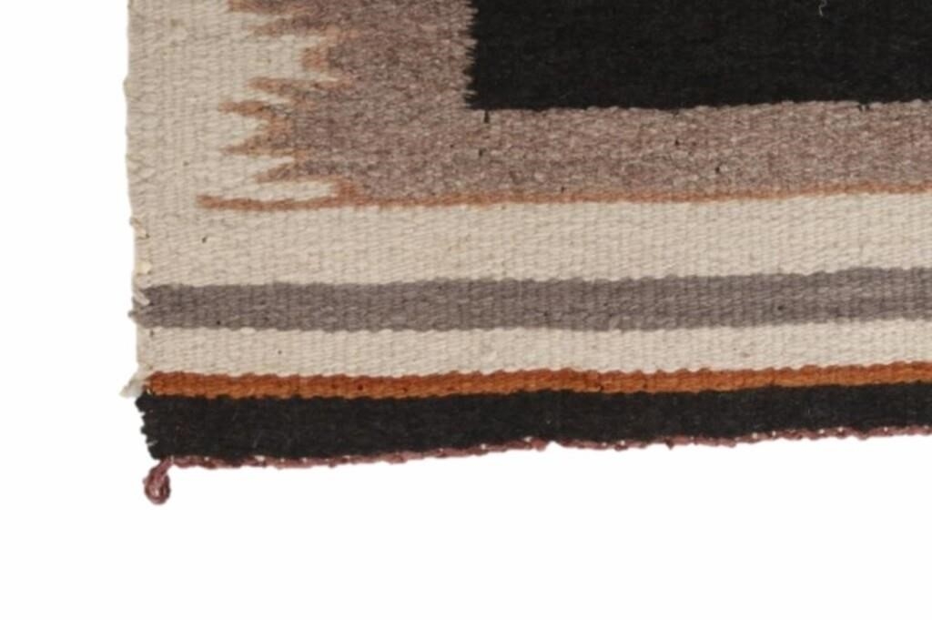 Artwork by Mae Benally, Navajo Eye Dazzler Crownpoint rug, Made of Dyed colors of light brown, black, grey, heathered grey, and cream set to a black field.
