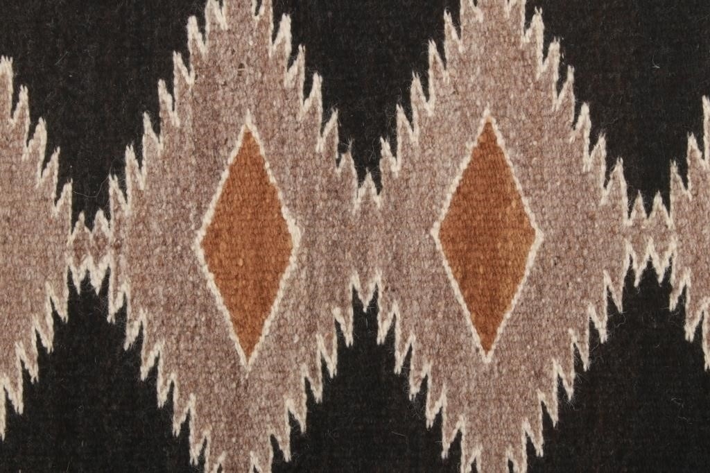 Artwork by Mae Benally, Navajo Eye Dazzler Crownpoint rug, Made of Dyed colors of light brown, black, grey, heathered grey, and cream set to a black field.