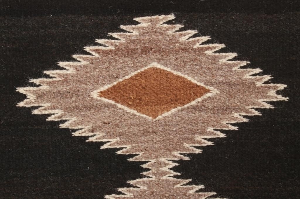 Artwork by Mae Benally, Navajo Eye Dazzler Crownpoint rug, Made of Dyed colors of light brown, black, grey, heathered grey, and cream set to a black field.