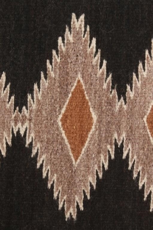 Artwork by Mae Benally, Navajo Eye Dazzler Crownpoint rug, Made of Dyed colors of light brown, black, grey, heathered grey, and cream set to a black field.
