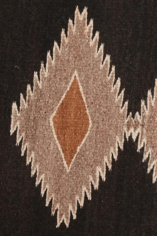 Artwork by Mae Benally, Navajo Eye Dazzler Crownpoint rug, Made of Dyed colors of light brown, black, grey, heathered grey, and cream set to a black field.