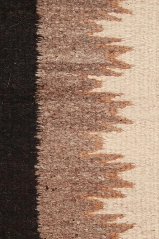Artwork by Mae Benally, Navajo Eye Dazzler Crownpoint rug, Made of Dyed colors of light brown, black, grey, heathered grey, and cream set to a black field.