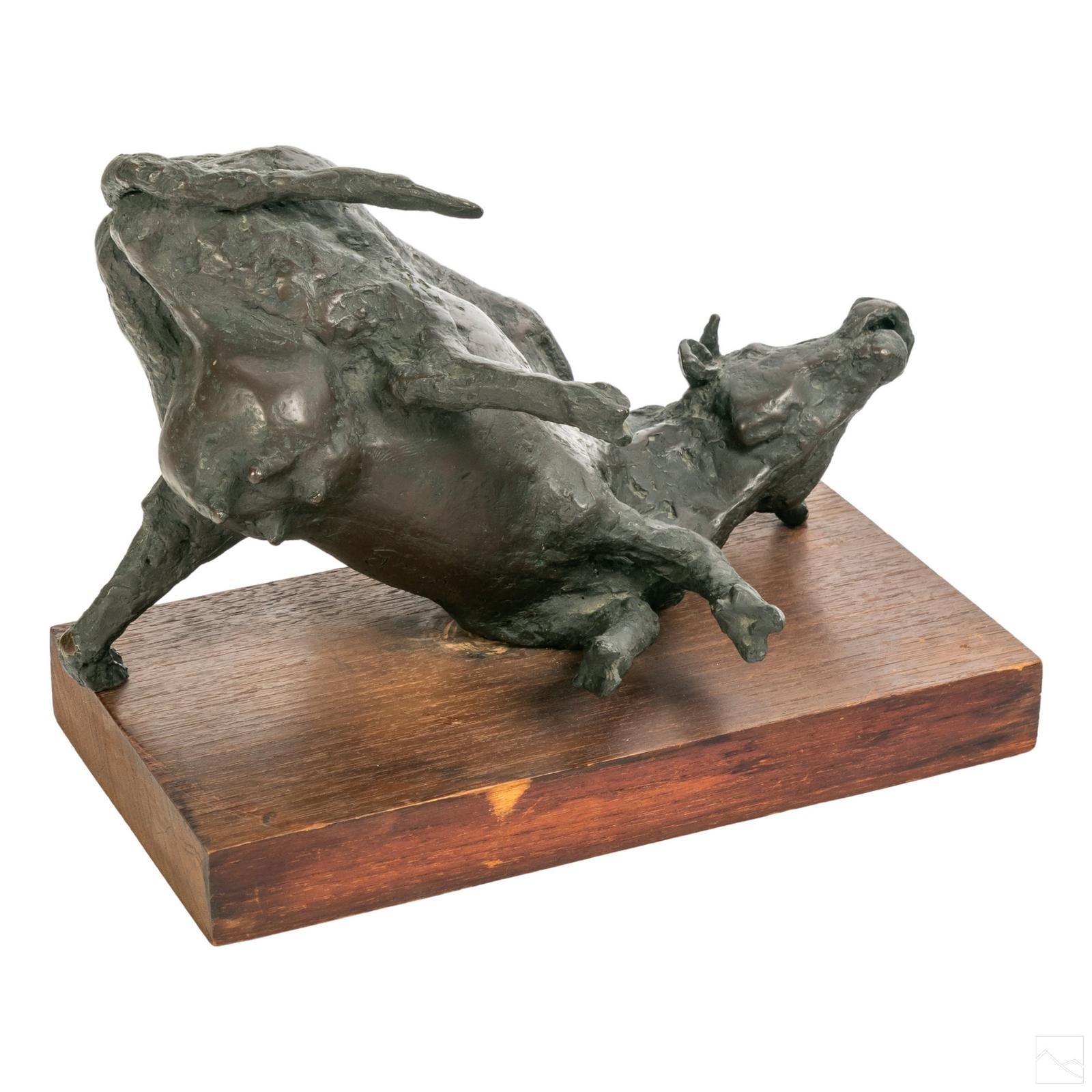 Artwork by Philip Grausman, Depicts a prone cow., Made of Bronze, wood plinth
