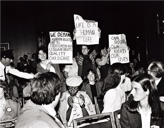 Sarah Shulman and other members of the Zap Action Brigade are arrested for disrupting the US Senate hearings on an anti-abortion bill. by Joan E. Biren, printed 1997