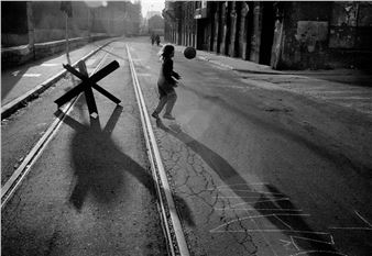 A kid playing with a ball next to a tank trap: Paul Lowe’s best photograph