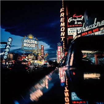 Fremont Street at night, lit by the neon signs of the casinos - Nat Farbman