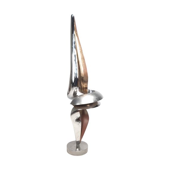A sleek, abstract sculpture featuring a twisted metal form with a sharp, upward-pointing tip.