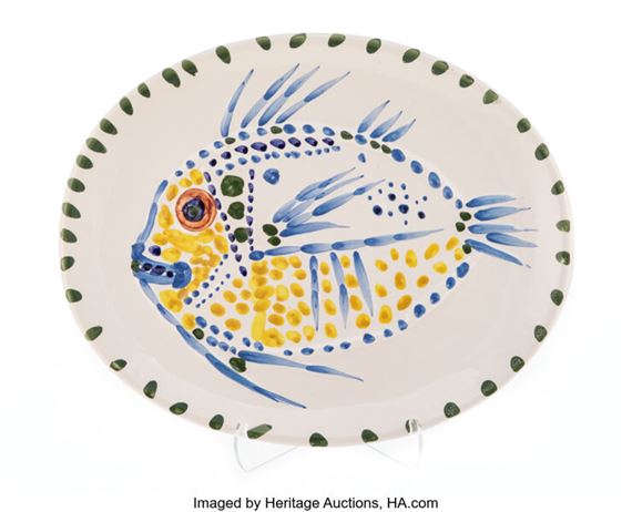 A decorative plate with a fish painted on it.