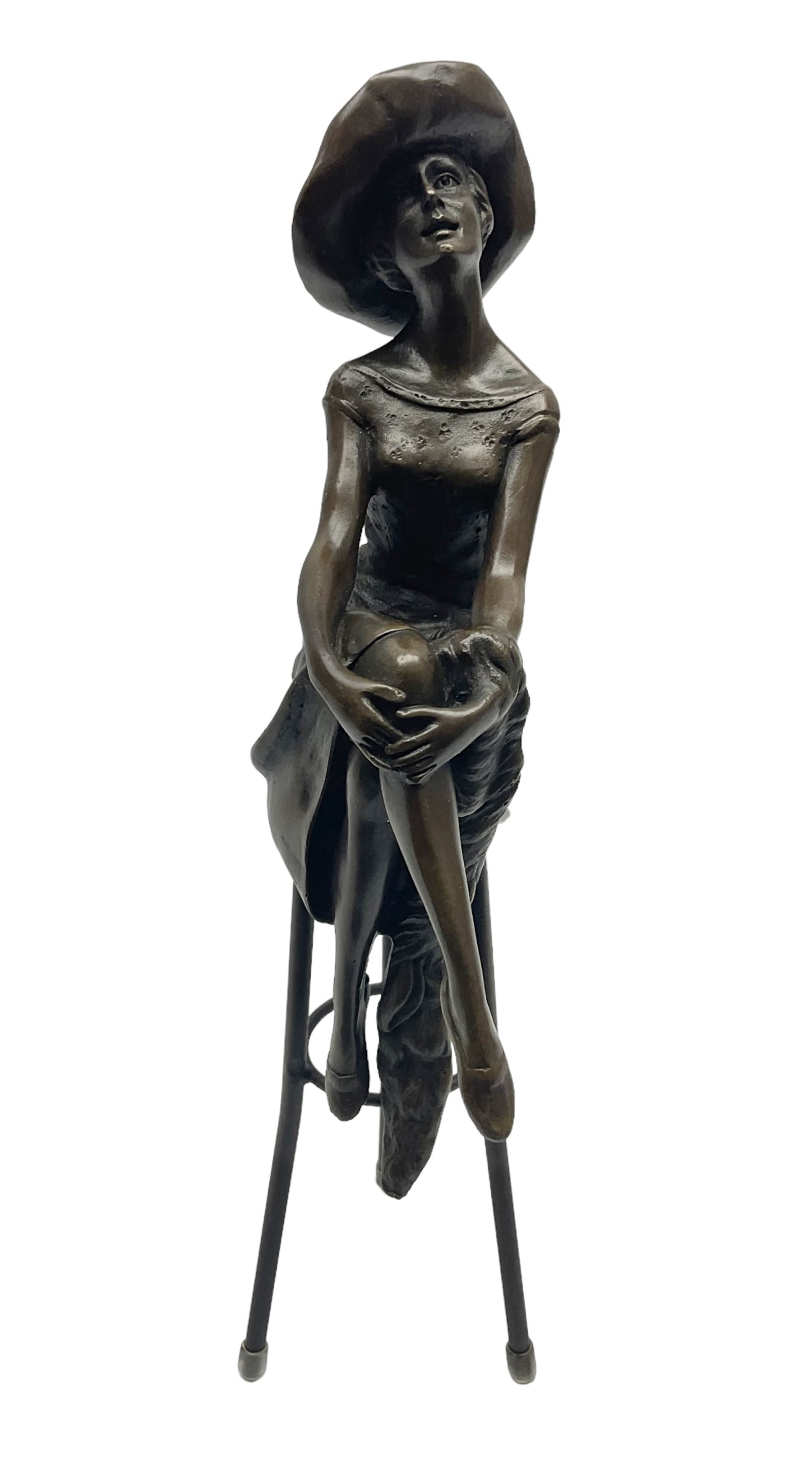 Pierre female figure seated cross legged upon a chair