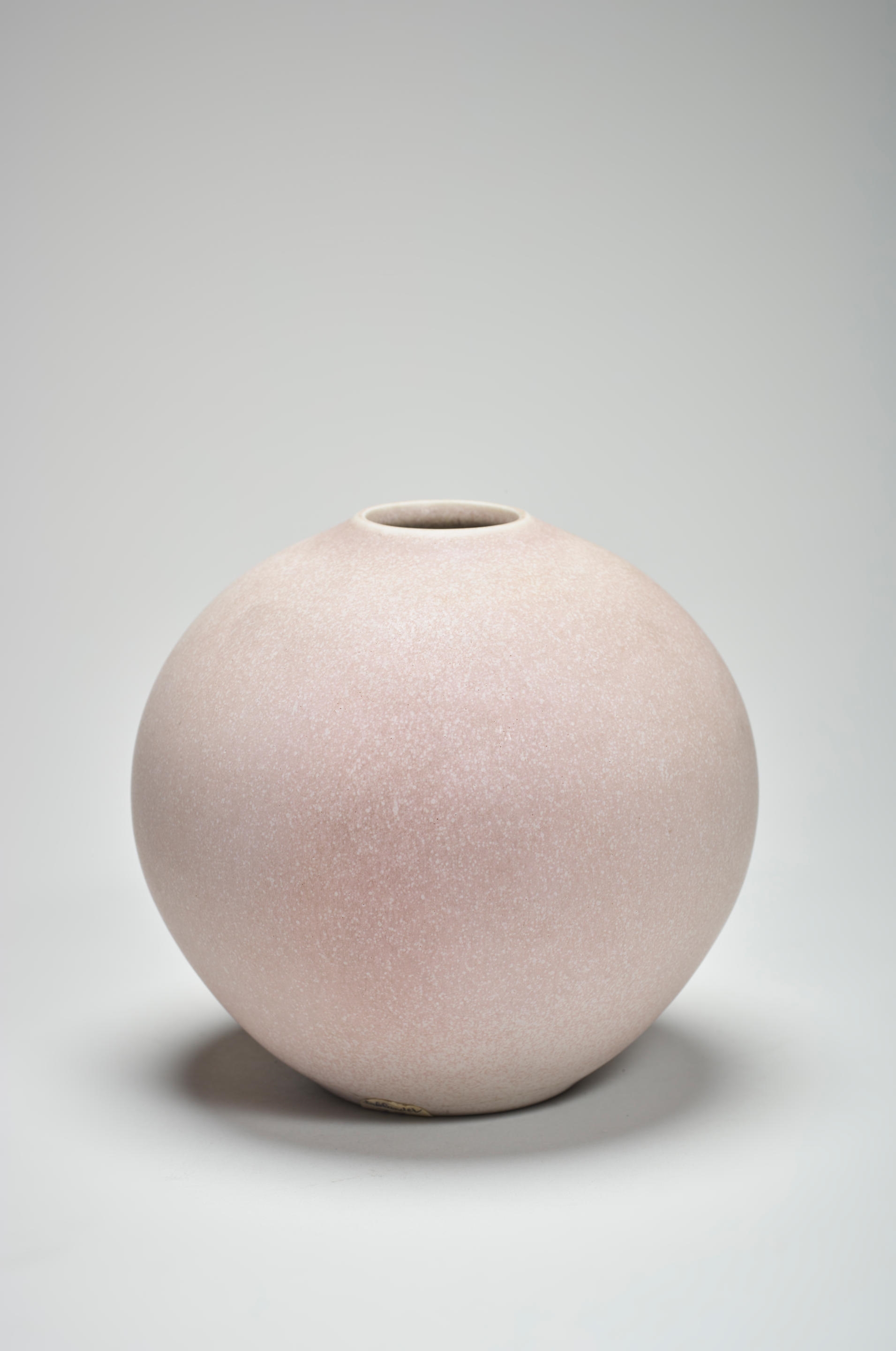Artwork by Robert Deblander, Vase boule, Made of Turned porcelain, matte pink enamel.
