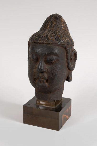 Chinese School, 12th Century | Head of Shakyamuni Buddha with a hairstyle  evoking clouds. Two curls of hair fall on the long ears of wisdom. Mouth  full of lips, eyes and eyebrows