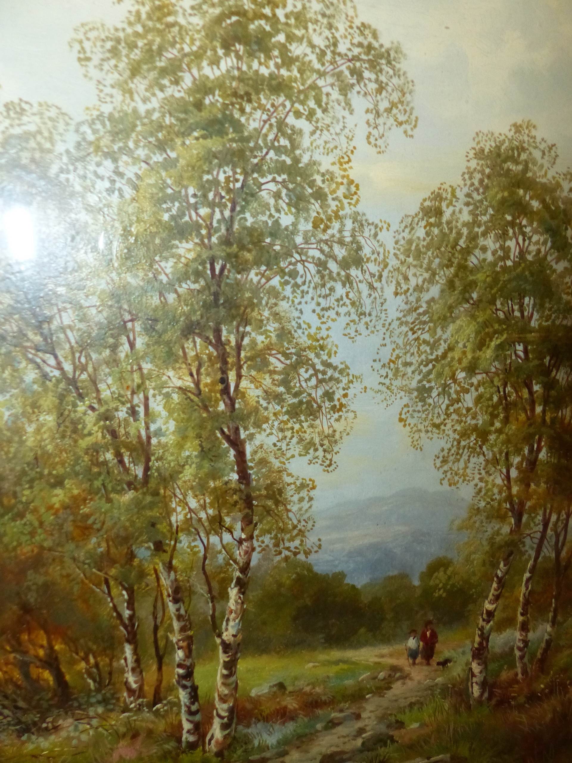 A framed landscape painting of birch trees in a field under an overcast sky.