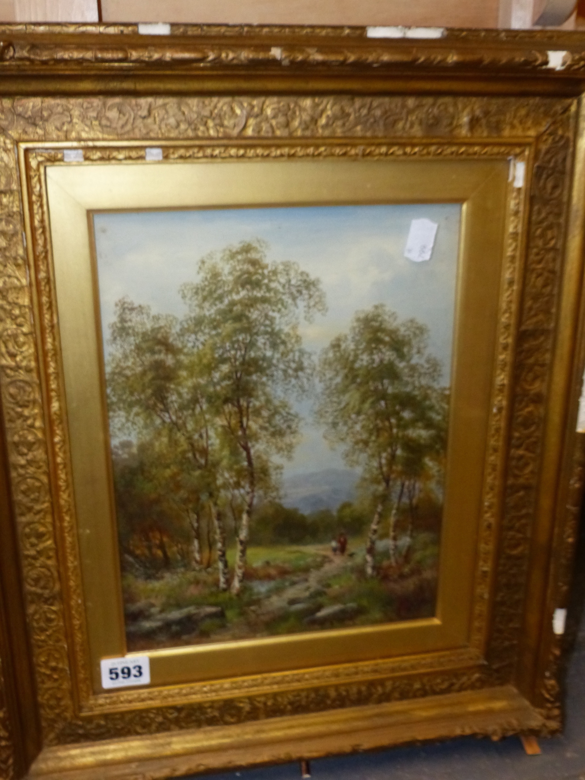 A framed landscape painting of birch trees in a field under an overcast sky.