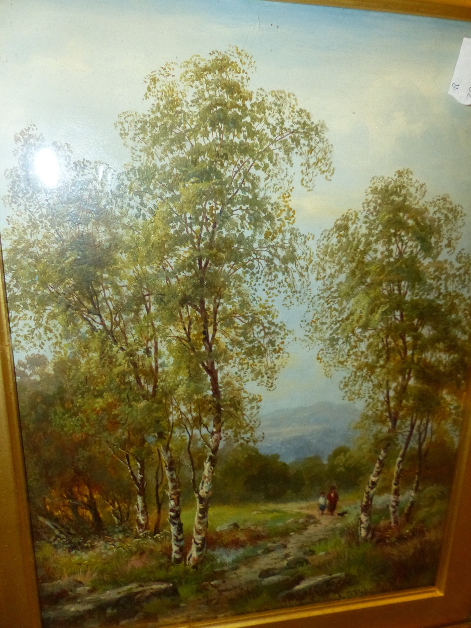 A framed landscape painting of birch trees in a field under an overcast sky.