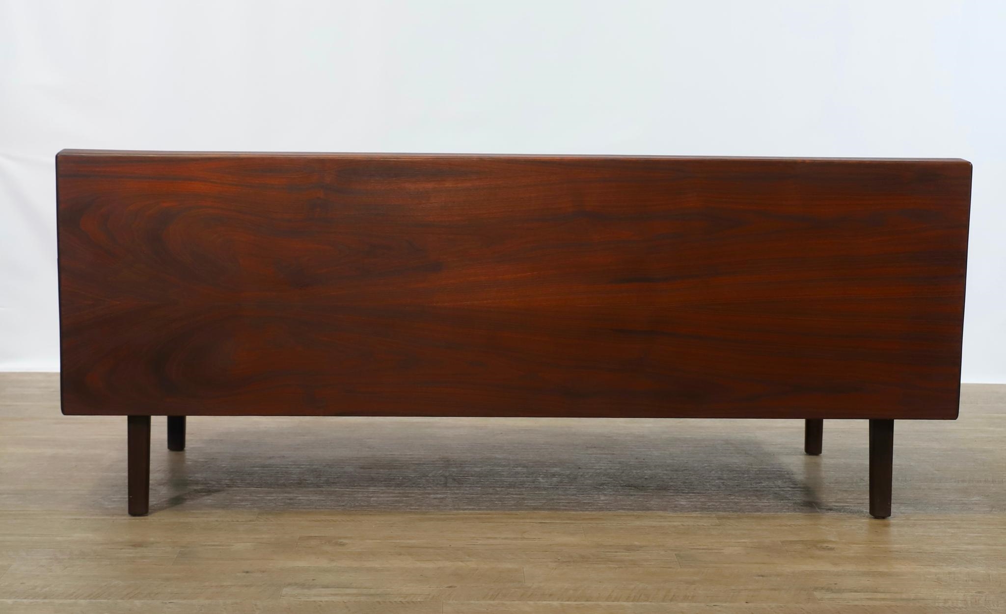 Artwork by Harvey Lowe, Sofa on slightly tapered square legs with multicolored diamond flame upholstered removable seat and back cushions, Made of olive green upholstery