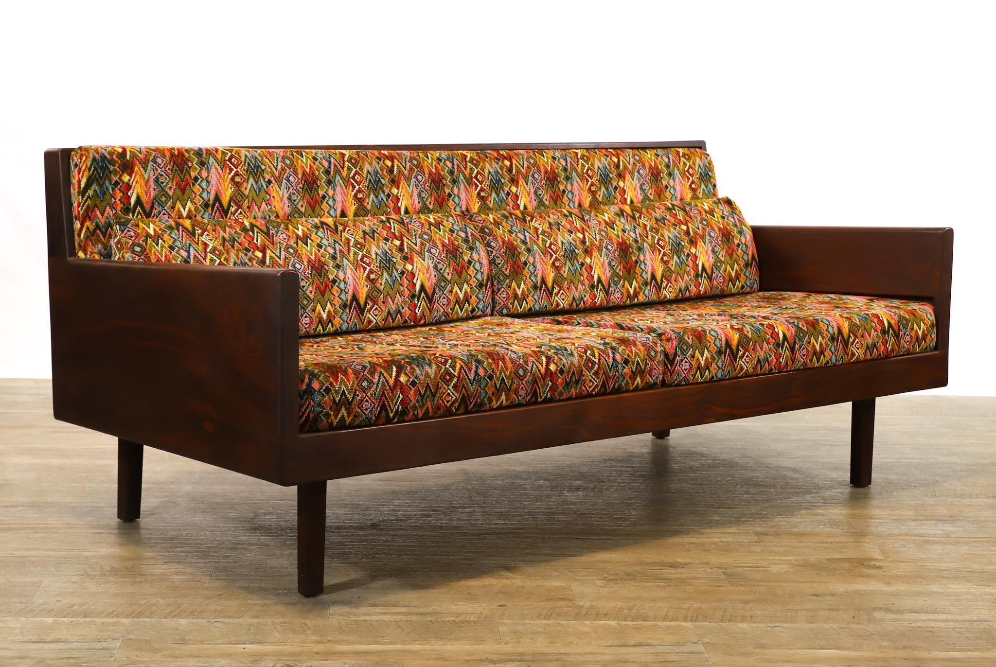 Artwork by Harvey Lowe, Sofa on slightly tapered square legs with multicolored diamond flame upholstered removable seat and back cushions, Made of olive green upholstery