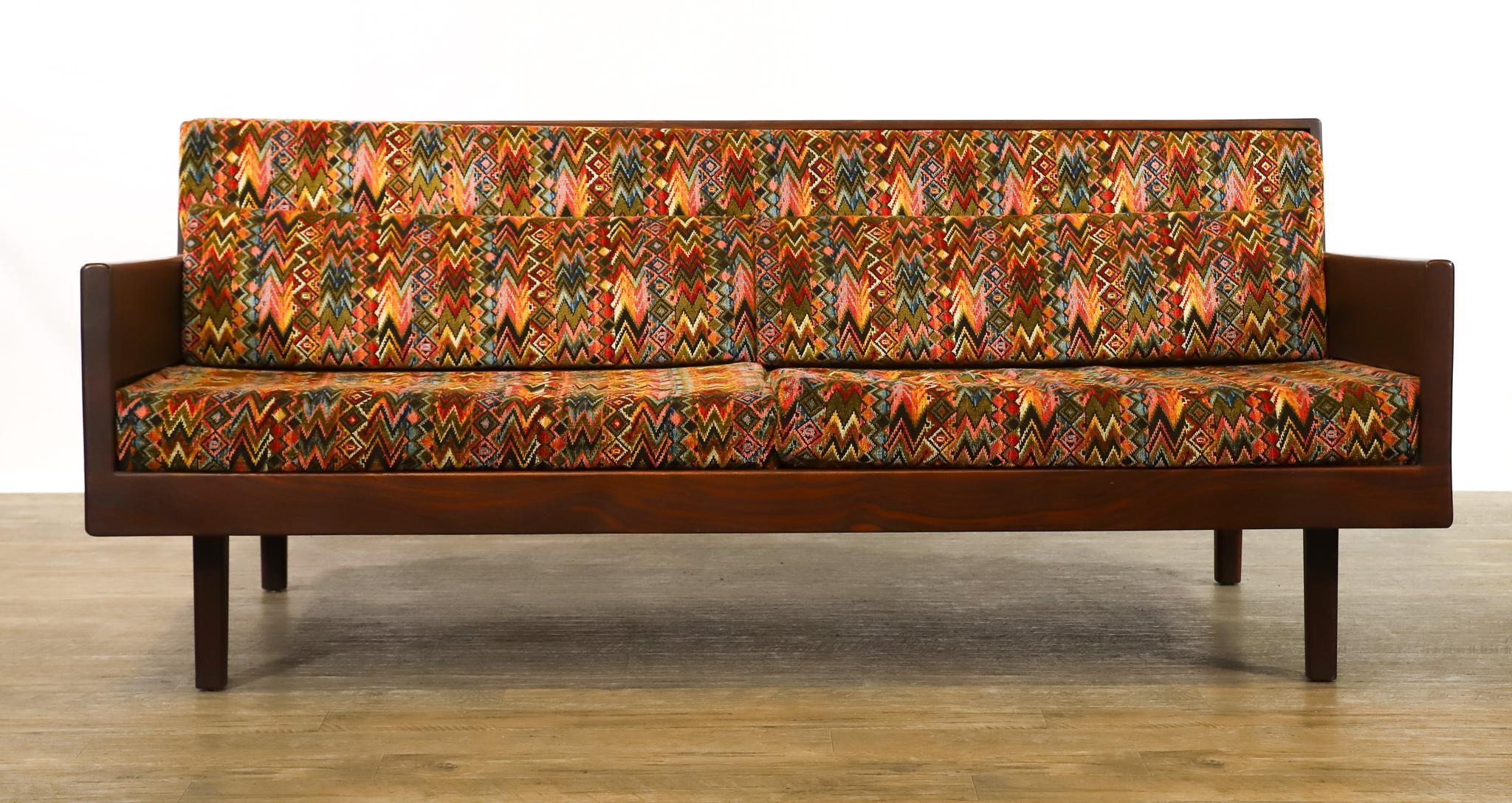Artwork by Harvey Lowe, Sofa on slightly tapered square legs with multicolored diamond flame upholstered removable seat and back cushions, Made of olive green upholstery