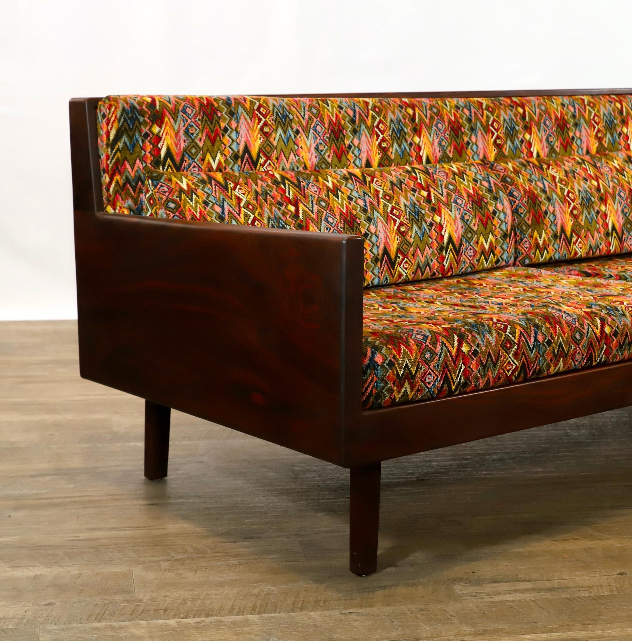 Artwork by Harvey Lowe, Sofa on slightly tapered square legs with multicolored diamond flame upholstered removable seat and back cushions, Made of olive green upholstery
