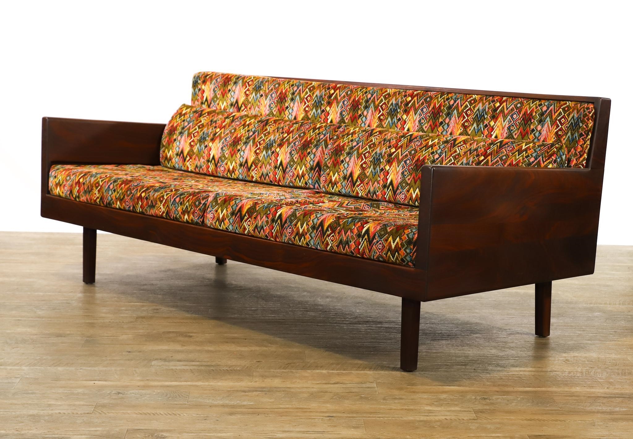 Artwork by Harvey Lowe, Sofa on slightly tapered square legs with multicolored diamond flame upholstered removable seat and back cushions, Made of olive green upholstery