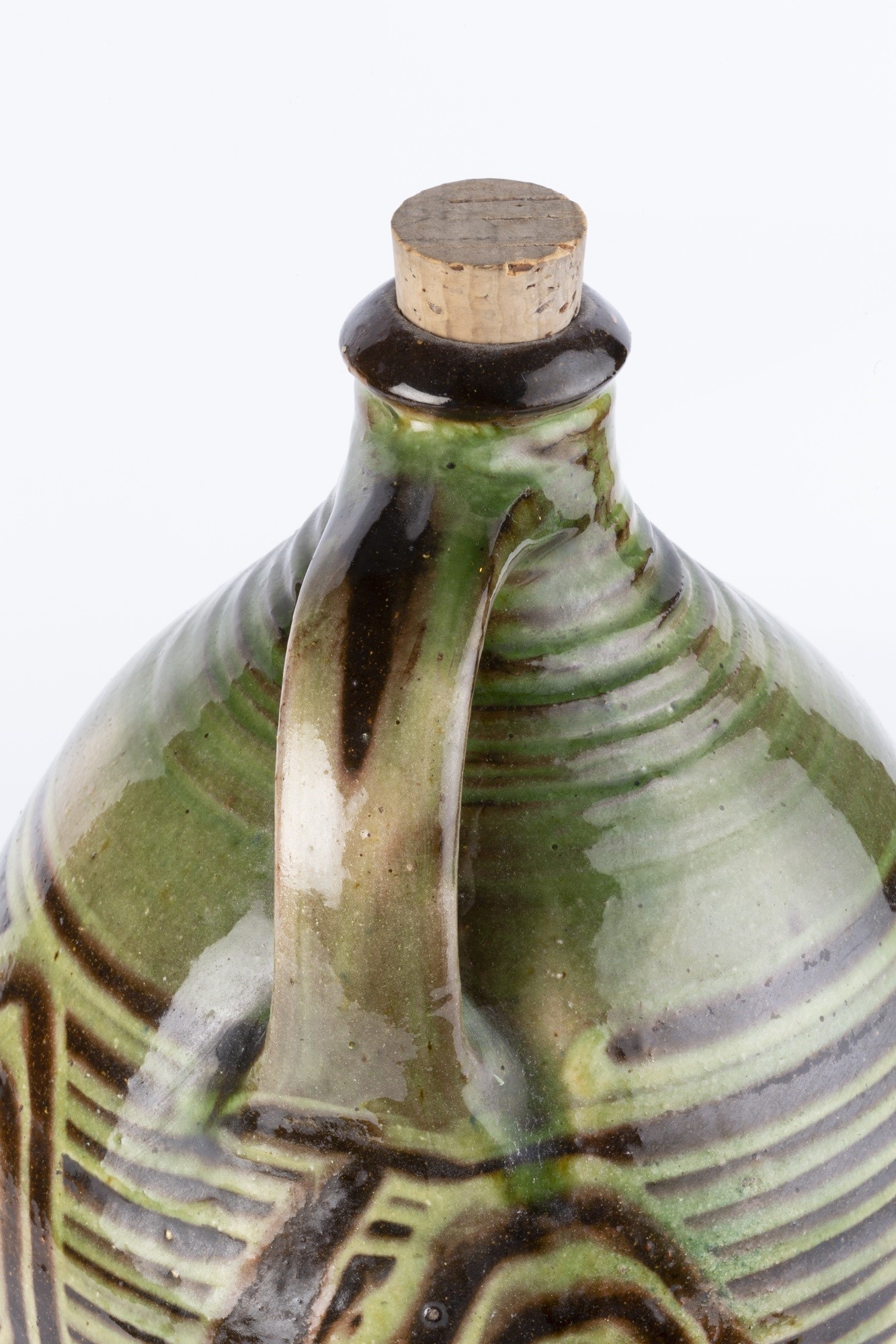 Michael Cardew Cider flagon with wave decoration on a green and