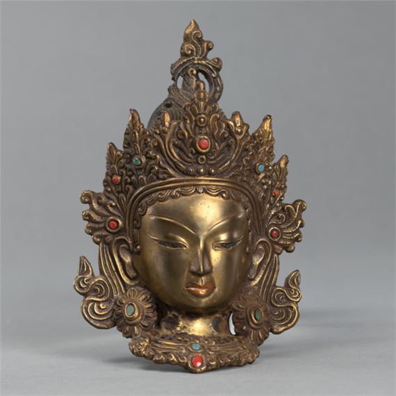 A BRONZE HEAD OF A CROWNED BODHISATTVA by Nepalese School, 2007