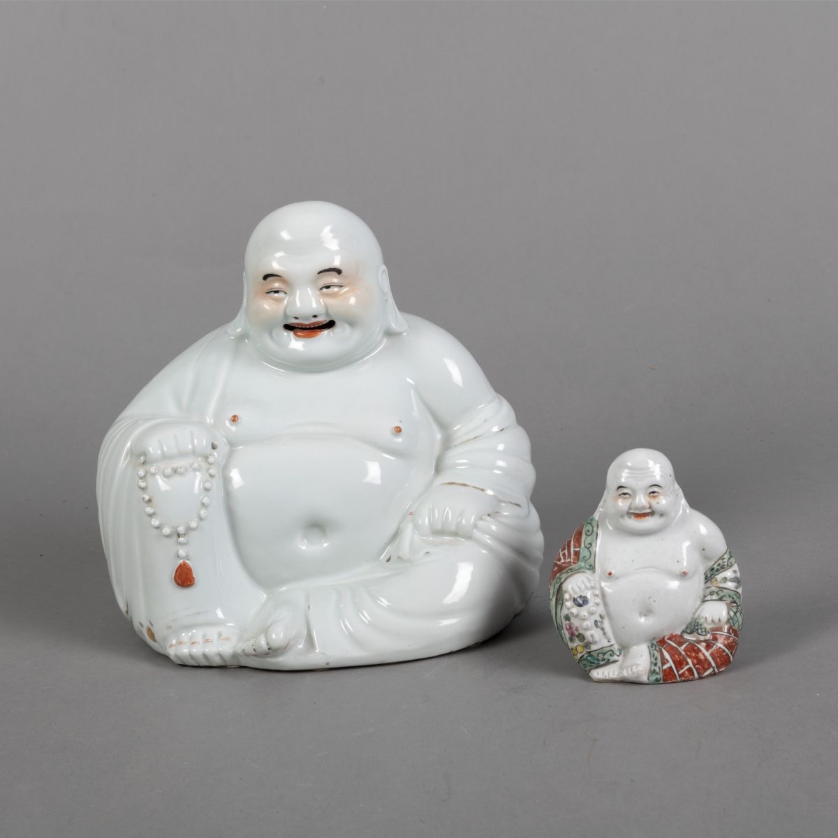 Artwork by Chinese School, TWO POLYCHROME PAINTED PORCELAIN FIGURES OF THE BUDAI, Made of POLYCHROME PAINTED PORCELAIN