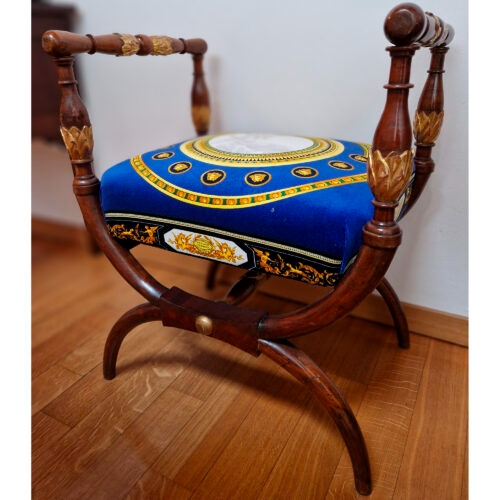 Artwork by Gianni Versace, Faldistorio, Made of natural and gilded wood with seat upholstered in smooth electric blue velvet with medallion depicting Cupid and Psyche