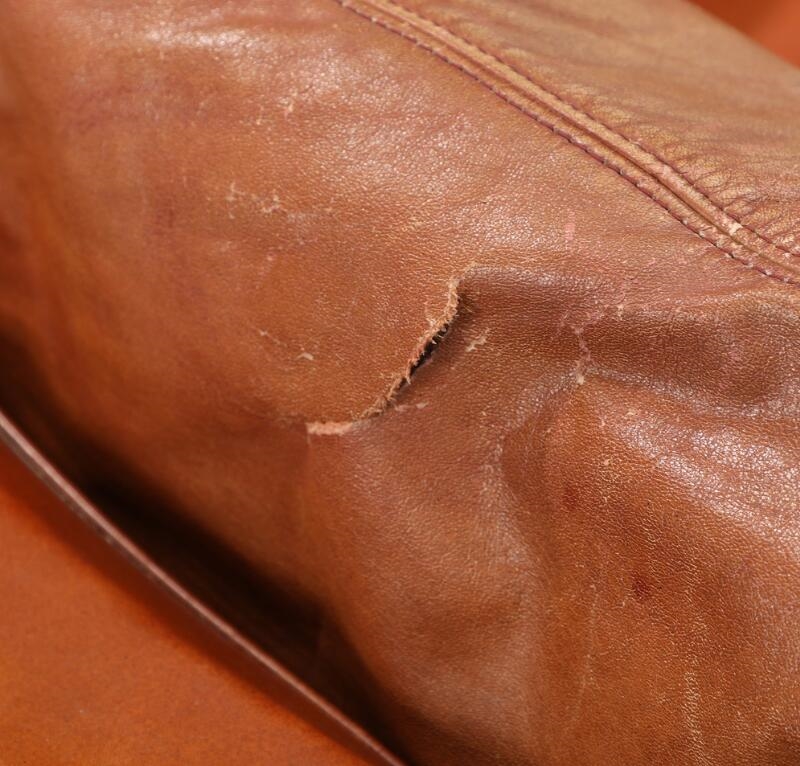 Artwork by Jacques Brule, A three seater sofa upholstered with cognac coloured leather, Made of coloured leather, chromed and black lacquered steel