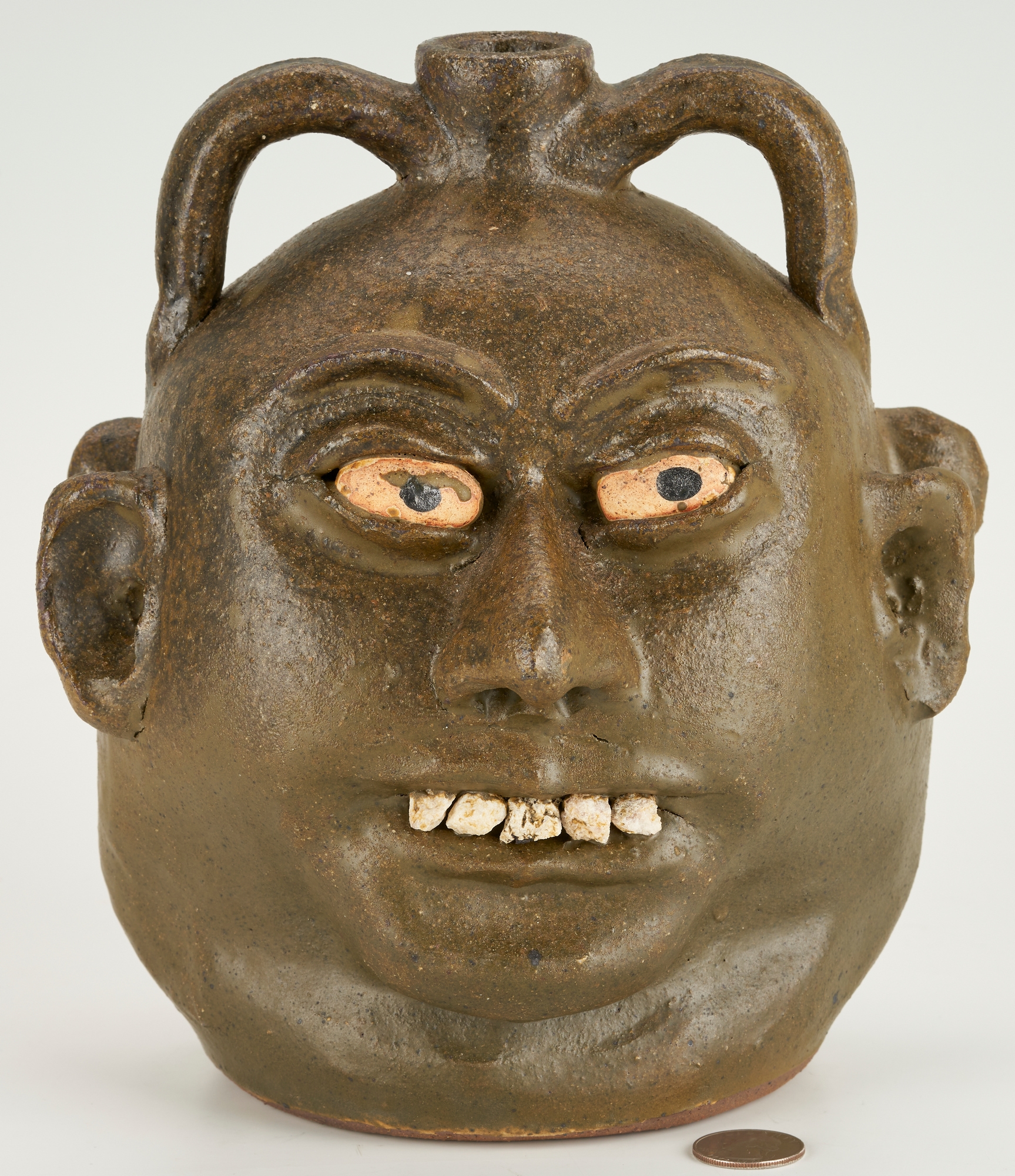 Artwork by Lanier Meaders, Lanier Meaders Folk Art Pottery Double Face Jug, Made of green matte glaze with