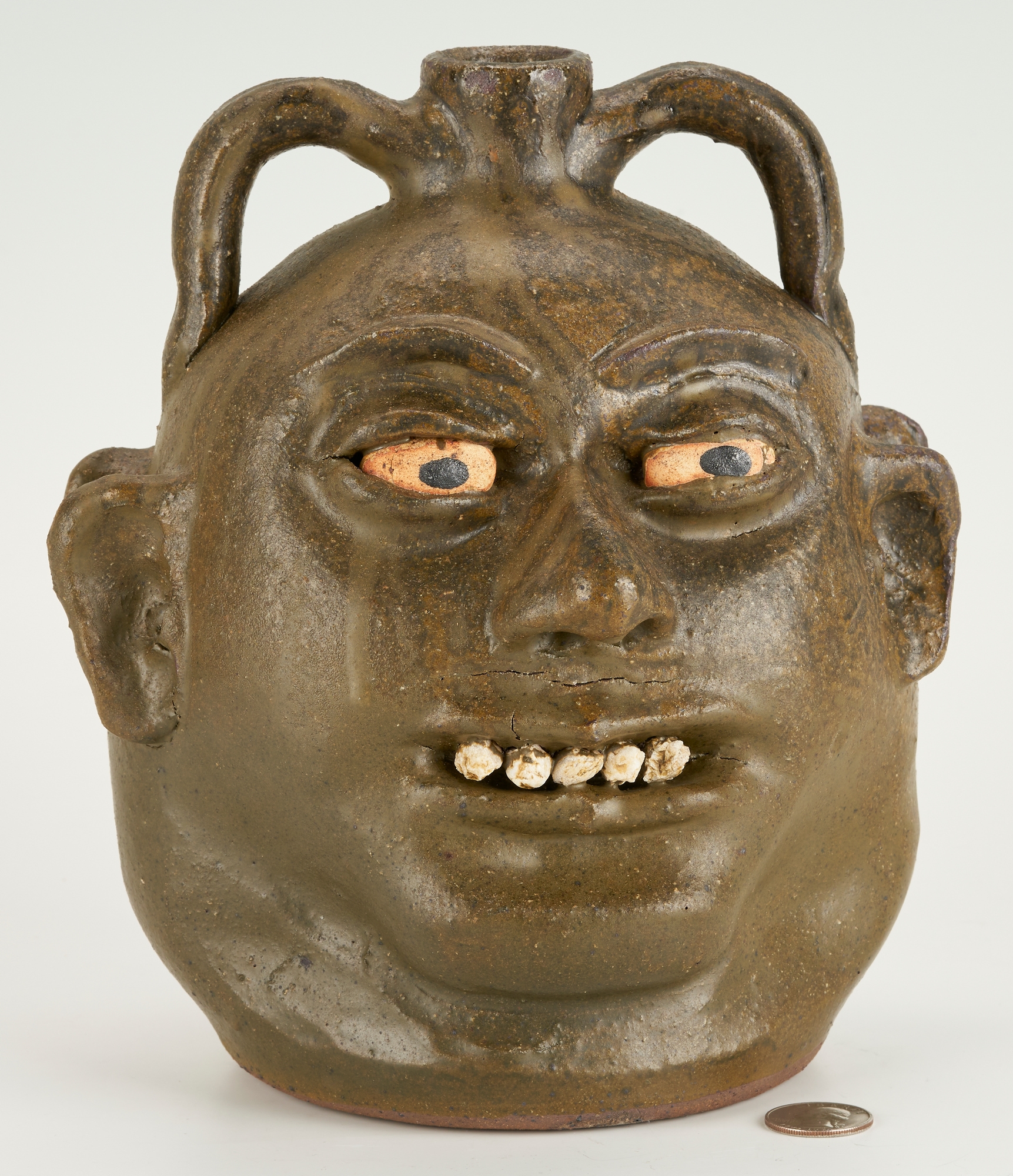 Artwork by Lanier Meaders, Lanier Meaders Folk Art Pottery Double Face Jug, Made of green matte glaze with