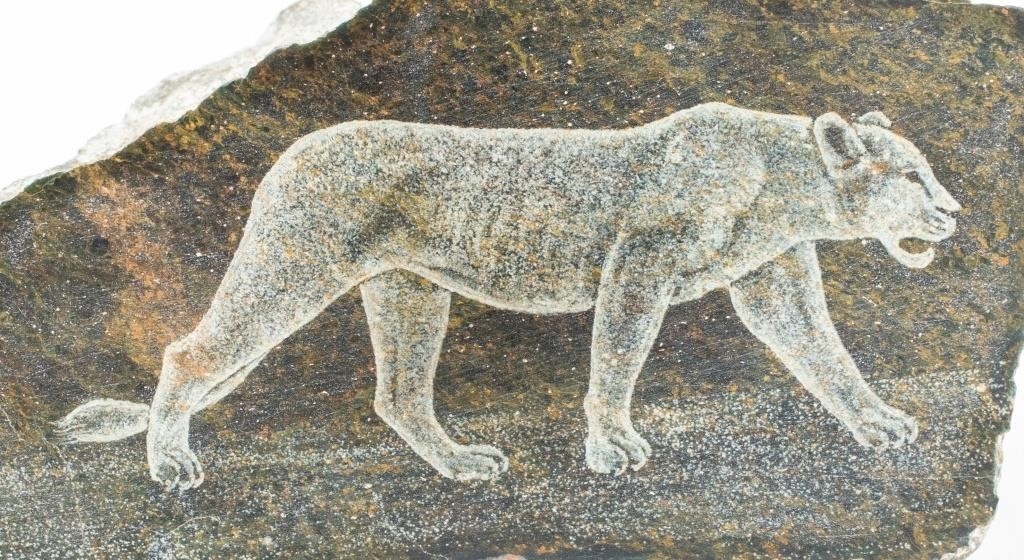 Artwork by Justie Mashile, Walking lioness, one with a lioness and cub, and the last with a lion, Made of green stone