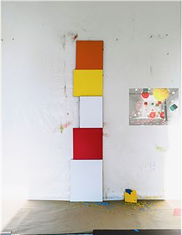 A minimalist composition of stacked colored rectangles against a textured white wall.