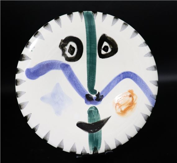 A plate with a face painted on it. 