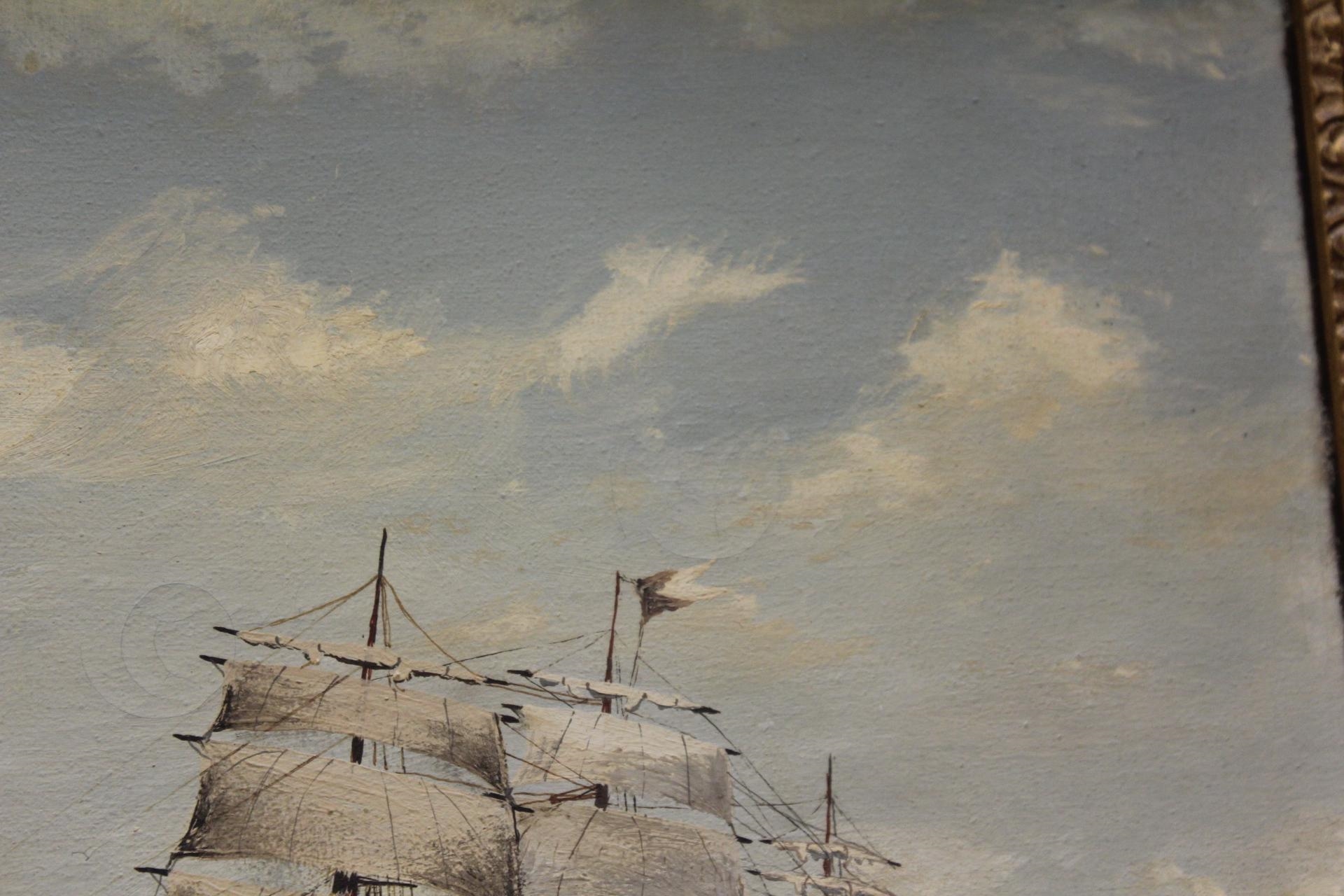A framed maritime painting of a tall sailing ship navigating choppy seas under a cloudy sky.