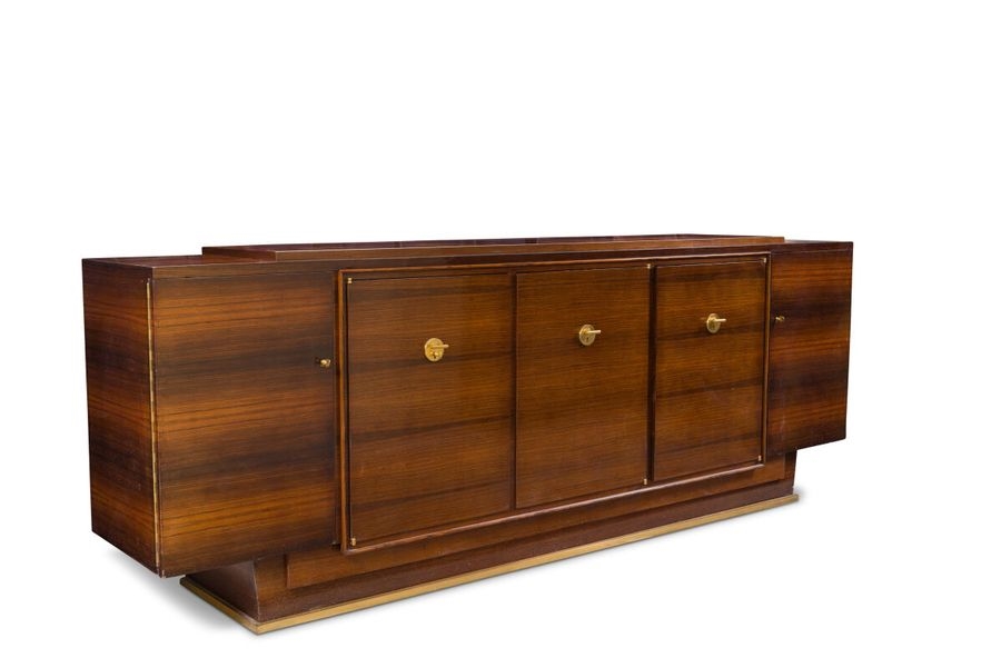 Artwork by Jules Leleu, Buffet en placage..., Made of Solid recessed base encircled by a brass band with a slight projection (wear, small detachments and veneer jumps). Keyholes and pull handles in gilded metal.