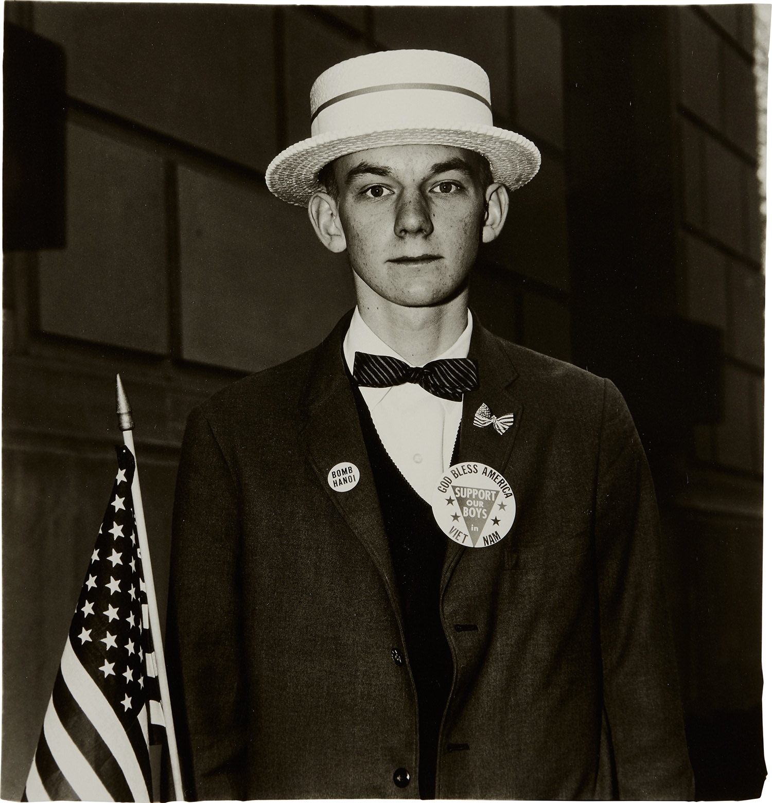 Artwork by Diane Arbus, Boy with a straw hat waiting to march in a pro-war parade, N.Y.C., Made of Gelatin silver print, printed later by Neil Selkirk.