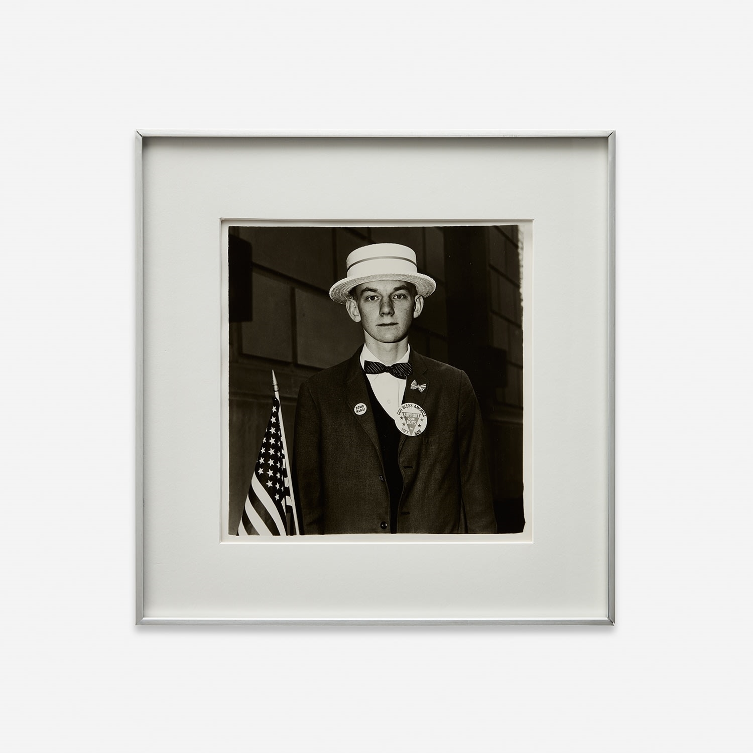 Artwork by Diane Arbus, Boy with a straw hat waiting to march in a pro-war parade, N.Y.C., Made of Gelatin silver print, printed later by Neil Selkirk.