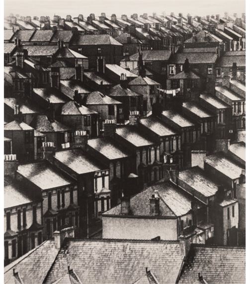A high-angle view of a dense urban neighborhood filled with tightly packed houses.