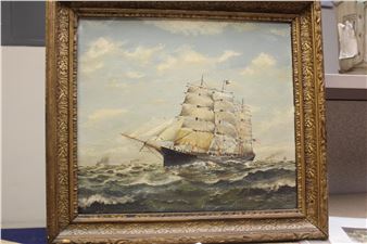 A framed maritime painting of a sailing ship navigating choppy seas under a cloudy sky.