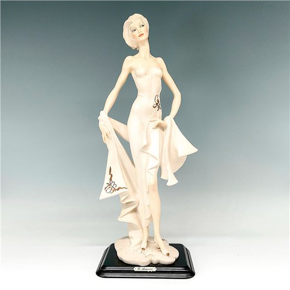 Beautiful figurine modeled as a graceful woman with cropped haircut dressed in a form fitting evening gown and sash; gold details and pastel details by Giuseppe Armani, 1990