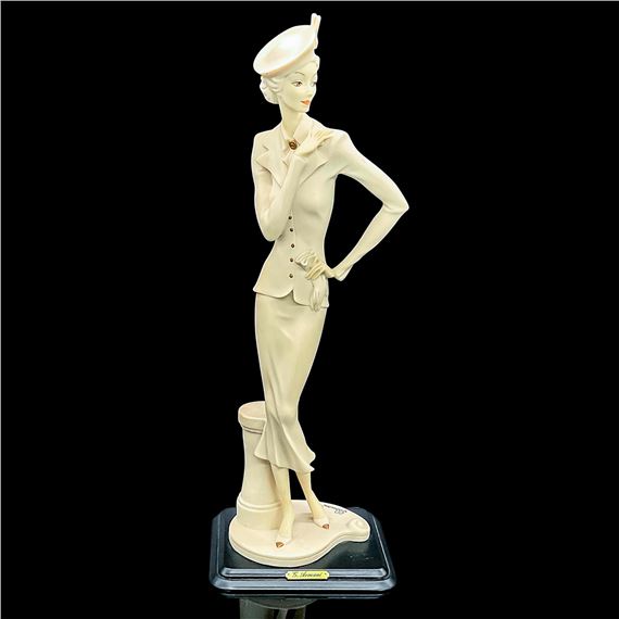 Matte figure of an finely dressed lady in a jacket, skirt and pillbox style hat holding her gloves by Giuseppe Armani, 1990