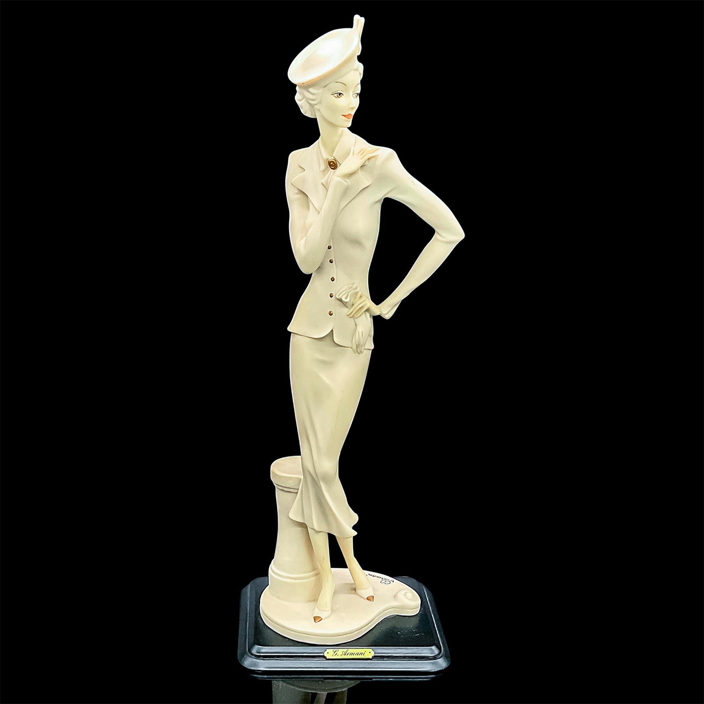 Artwork by Giuseppe Armani, Matte figure of an finely dressed lady in a jacket, skirt and pillbox style hat holding her gloves, Made of Figurine