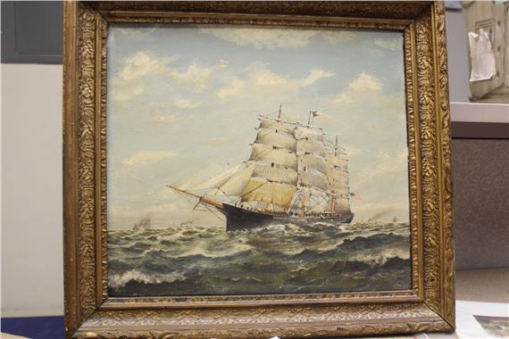 A seascape painting of a large sailing ship navigating choppy waters under a cloudy sky, framed in ornate gold.