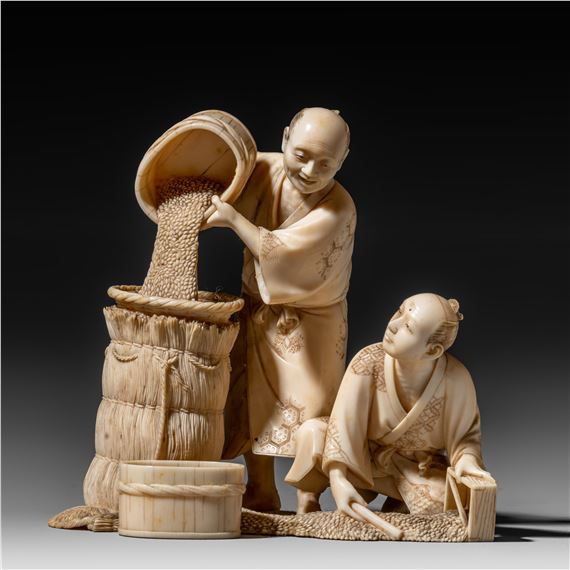 A Japanese ivory okimono of wheat farmers at work