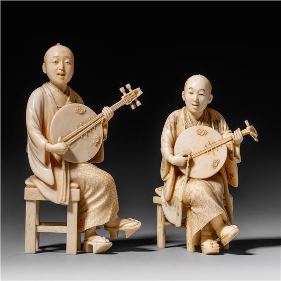 Two Japanese ivory okimono of men playing the biwa and singing