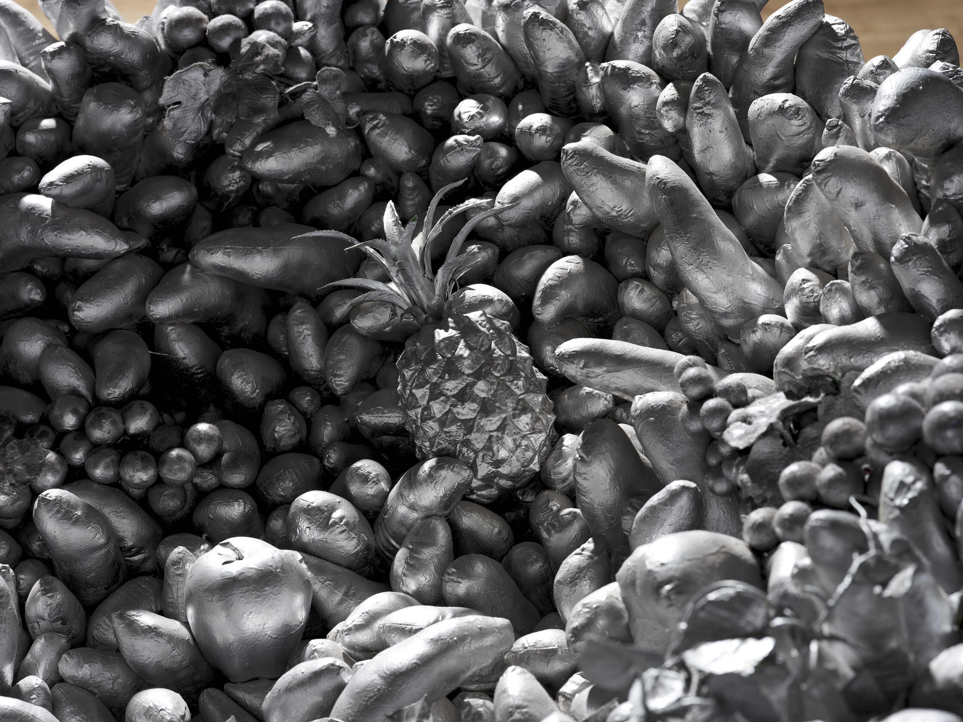 Artwork by Yayoi Kusama, Walking on the Sea of Death, Made of sewn stuffed fabric, plastic fruits, fiberglass rowboat, silver paint sculpture