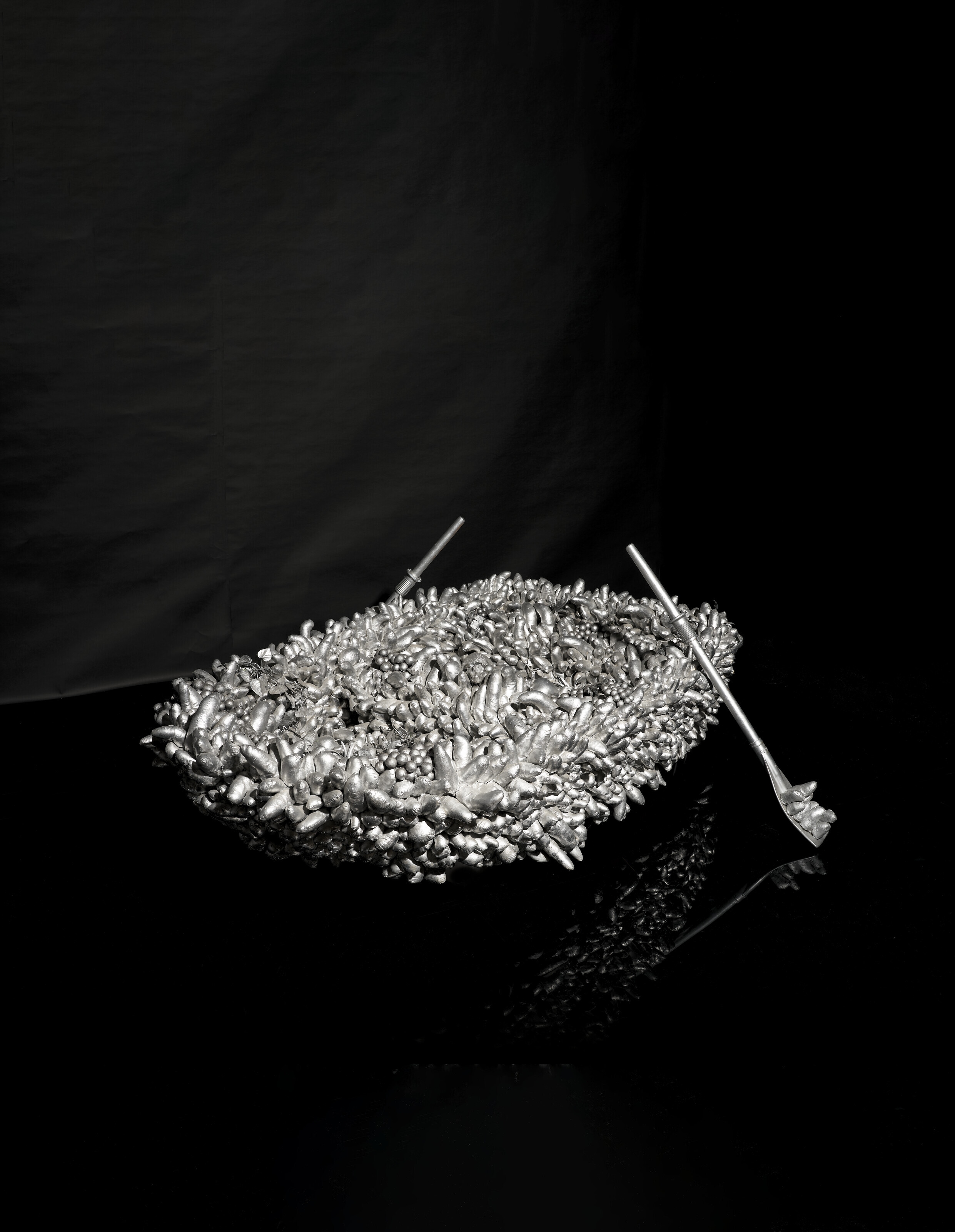 Artwork by Yayoi Kusama, Walking on the Sea of Death, Made of sewn stuffed fabric, plastic fruits, fiberglass rowboat, silver paint sculpture