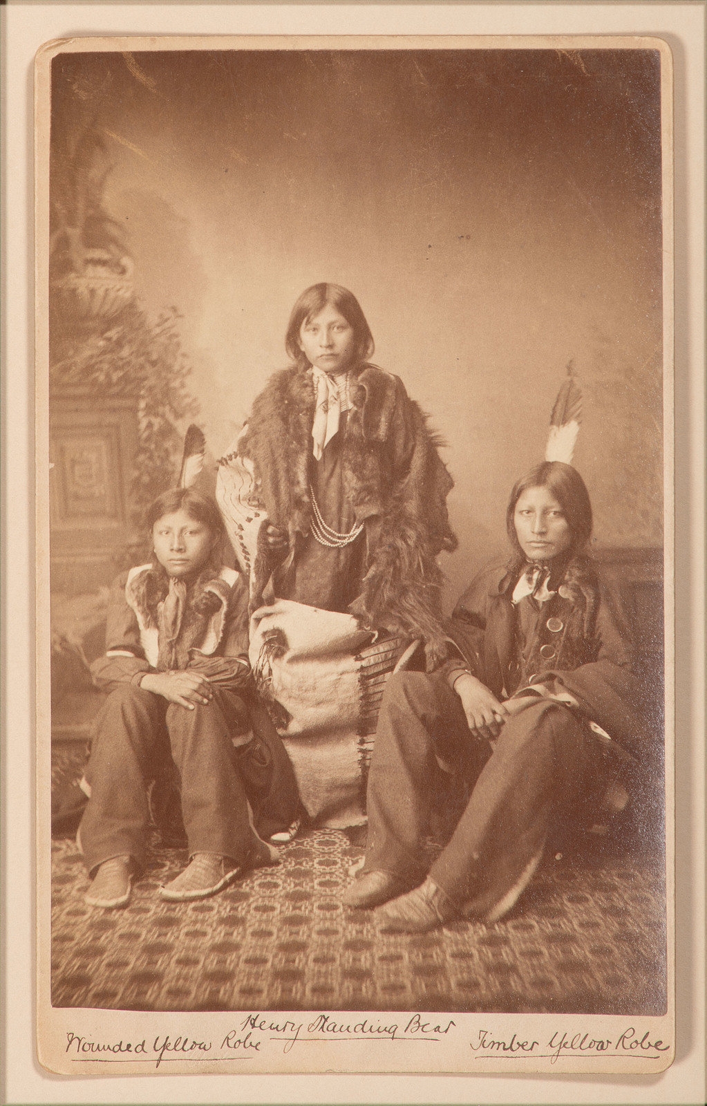 Artwork by John Nicholas Choate, Boudoir card featuring a trio of Santee Sioux students of Carlisle Indian School, identified on mount as Henry Standing Bear, Made of Boudoir card